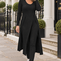 Adult woman in London wearing the black ribbed Amelie lounge set with split tunic