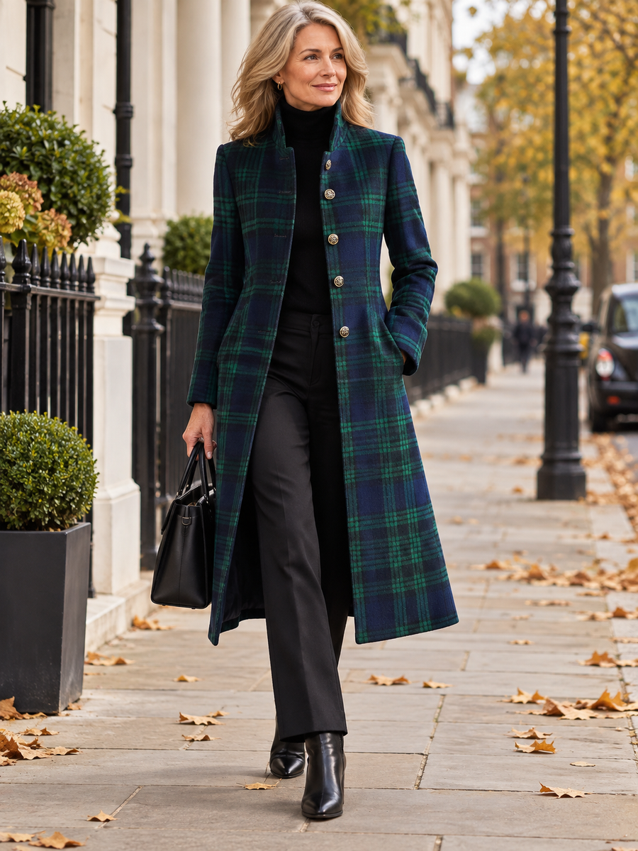 Blue-green check longline midi jacket worn by a woman walking in London