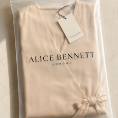 Apricot V-neck wrap jumpsuit in an Alice Bennett London polyzip bag with branded hangtag