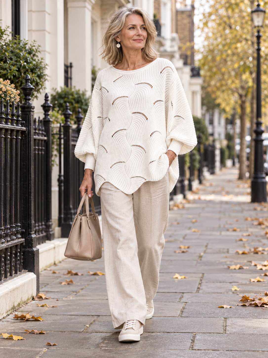 Coravina textured open-knit jumper on a woman walking in London