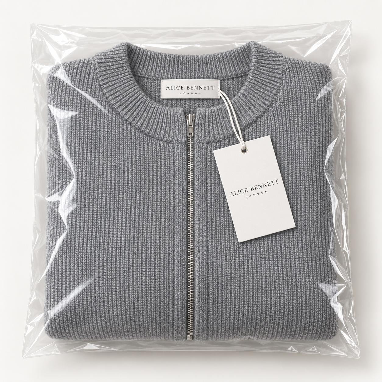 Evelyn soft grey zip-up cardigan folded in Alice Bennett London packaging
