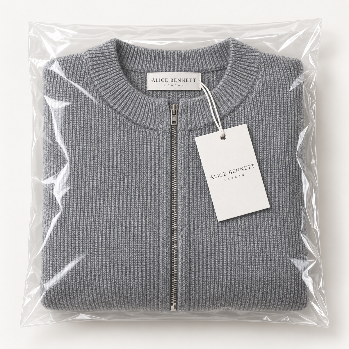 Evelyn soft grey zip-up cardigan folded in Alice Bennett London packaging