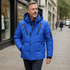 Harris blue padded hooded winter jacket worn by a man walking in London