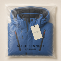 Harris blue padded hooded winter jacket folded in a semi-transparent Alice Bennett London polybag with hangtag