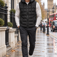 Lucas black hooded puffer vest worn by a man walking in London