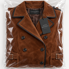 Folded brown trench coat in Alice Bennett London packaging