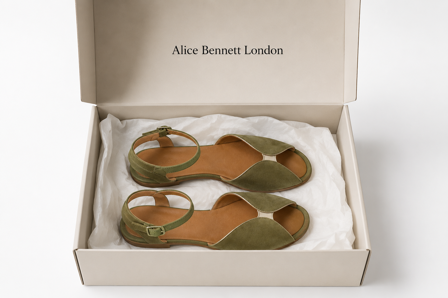 Olivia green wraparound sandals arranged horizontally in an Alice Bennett London shoe box