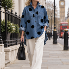 Woman wearing the blue polka-dot denim top while walking in London