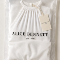 White sleeveless wide-leg jumpsuit in an Alice Bennett London polyzip bag with branded hangtag