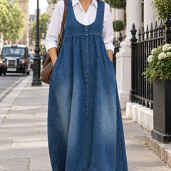 Veronica blue denim maxi pinafore dress worn by a mature woman walking in London