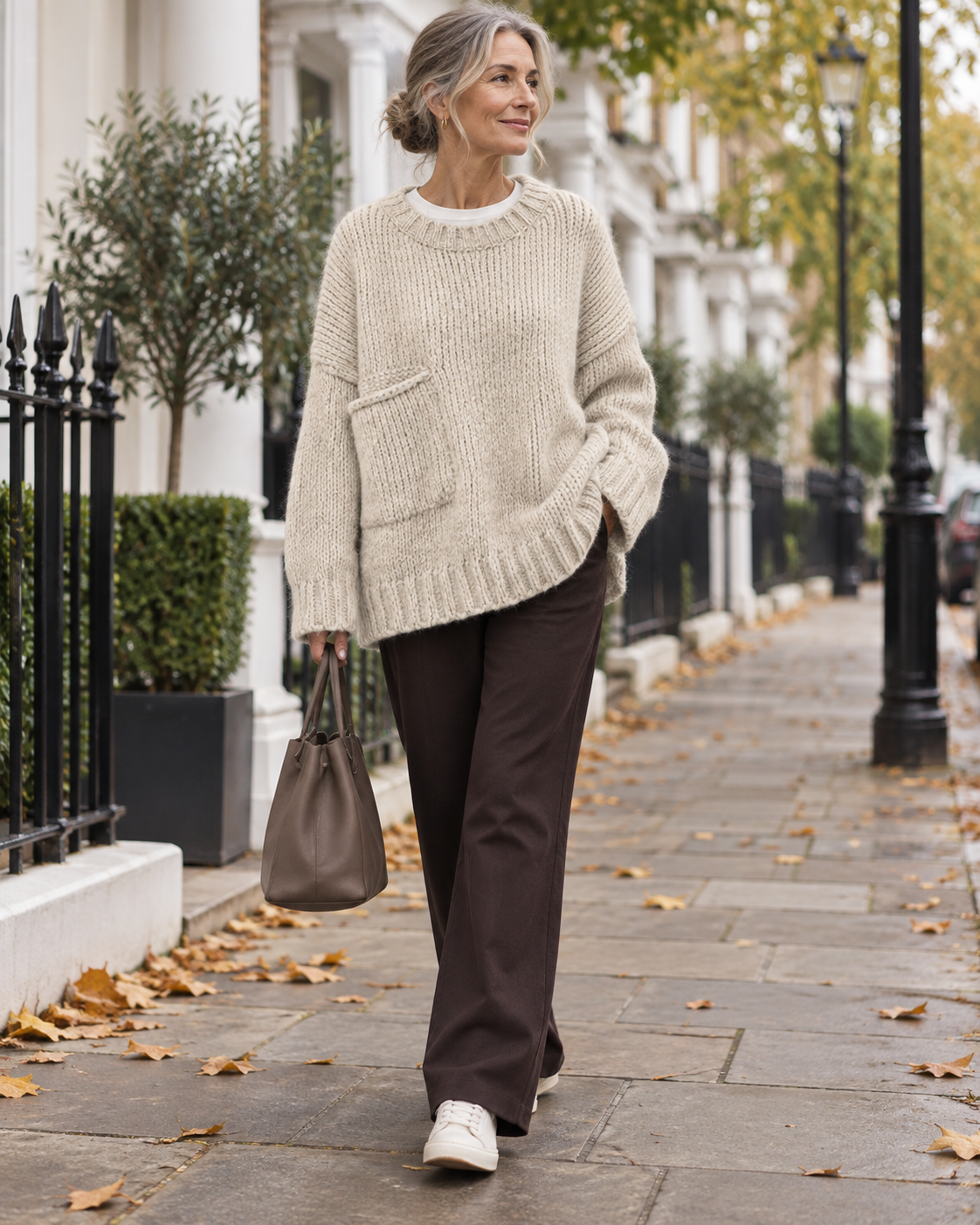 Vivian white oversized chunky knit sweater worn by a mature woman on a London street