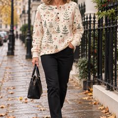 Woman wearing the cream Christmas tree print pullover sweater walking in London
