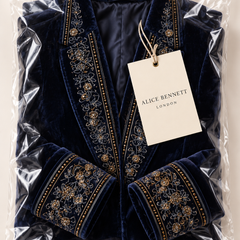 Navy long vintage jacket with ornate embroidery in Alice Bennett London packaging