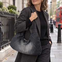Zara crescent denim shoulder bag carried by a woman in London